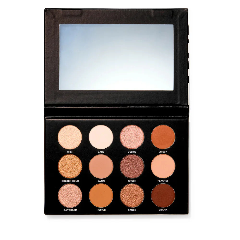 Open eyeshadow palette with 12 warm-toned shades, mirror, and names like Golden Hour and Drama