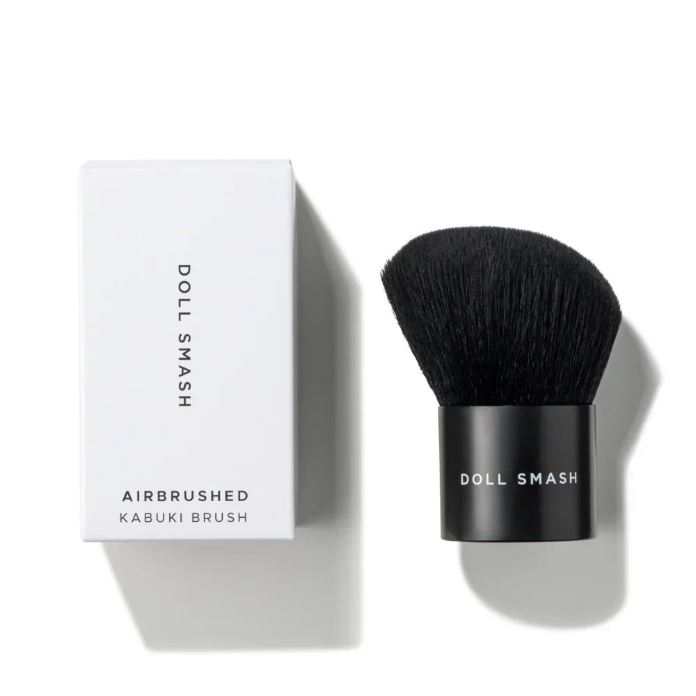 Doll Smash Airbrushed Kabuki Brush with sleek black bristles and minimalist white packaging